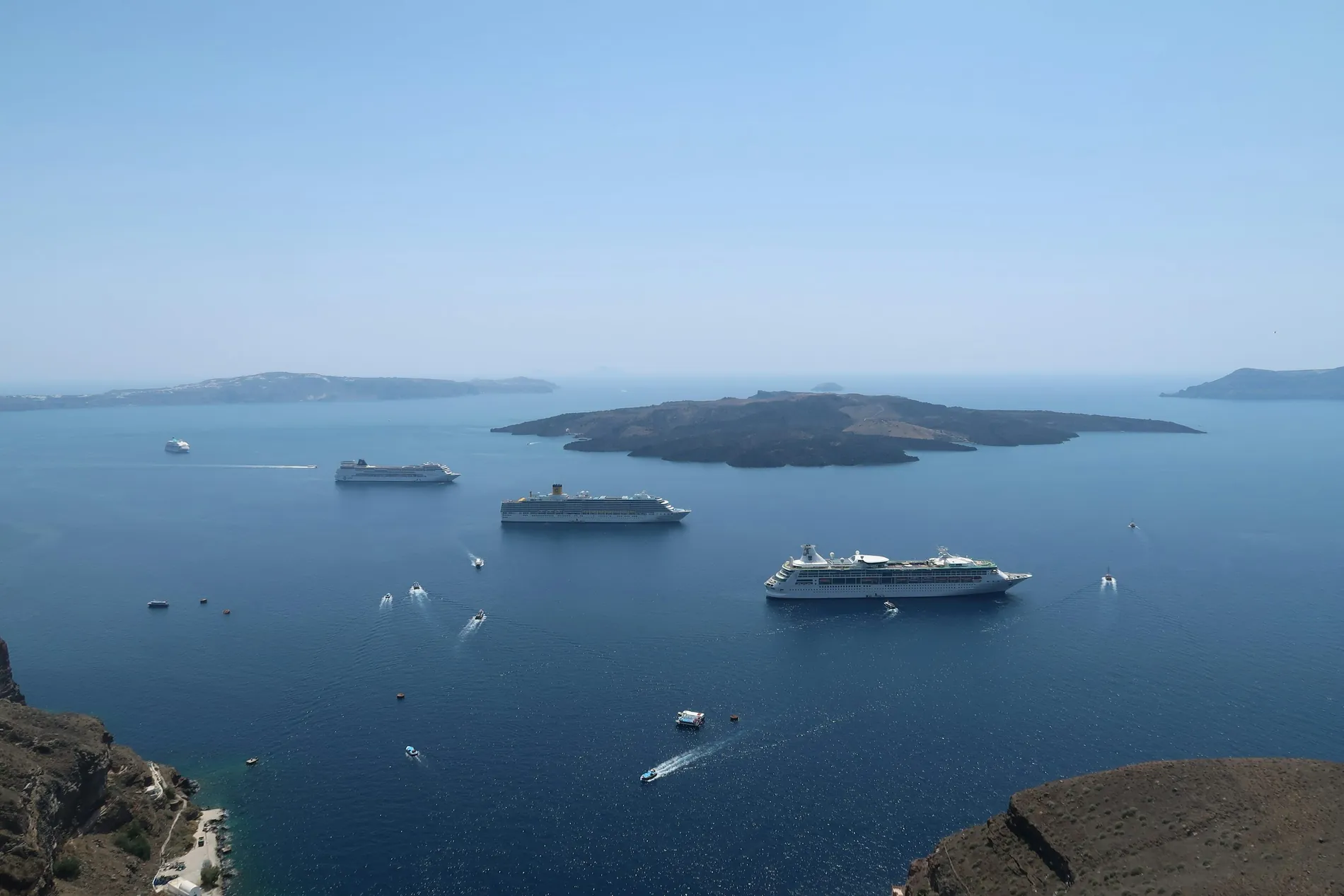 Cruise ships anchored in a sunlit Mediterranean bay